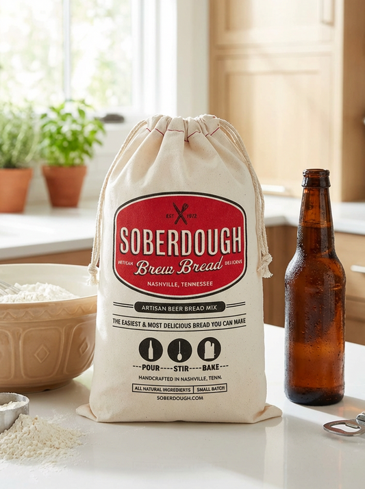 Bag of Soberdough Brew Bread mix on a kitchen counter with a bottle of beer and mixing bowl.
