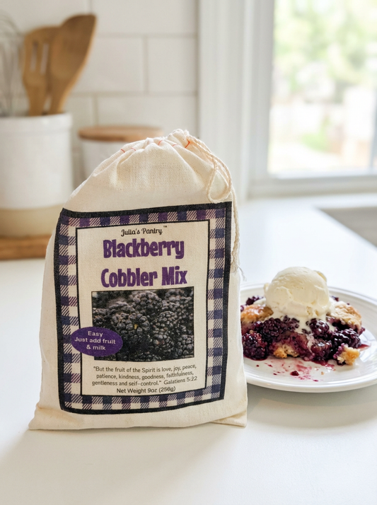 Bag of Blackberry Cobbler Mix on a kitchen counter with a plate of dessert.