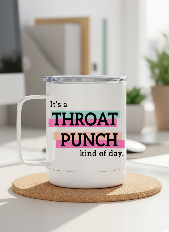 White mug with colorful text on a desk in an office setting